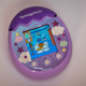 A photo of the Tamagotchi Pix laying on a table
